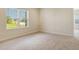 Bedroom with neutral carpet, large window, and view to the outside at 12570 Brookgreen St, Venice, FL 34293