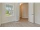 Bright bedroom with window, wood-look flooring, neutral wall color, and white doors at 12570 Brookgreen St, Venice, FL 34293