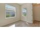 Bright bedroom with window, wood-look flooring, neutral wall color, and white doors at 12570 Brookgreen St, Venice, FL 34293