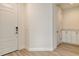 Inviting hallway with white trim, neutral walls, and wood-look flooring at 12570 Brookgreen St, Venice, FL 34293