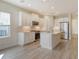 Modern kitchen with white cabinets, stainless steel appliances, and a stylish center island at 12570 Brookgreen St, Venice, FL 34293