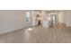 Bright living room showcasing wood-look tile flooring and an open layout to the kitchen at 12570 Brookgreen St, Venice, FL 34293