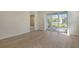 The living room has tile floors and a view to the screened patio at 12570 Brookgreen St, Venice, FL 34293