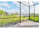 Screened-in patio with brick flooring overlooking a grassy yard and scenic water view at 12570 Brookgreen St, Venice, FL 34293