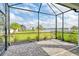 The covered and screened patio overlooks the lake and lawn area at 12570 Brookgreen St, Venice, FL 34293