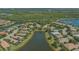 Aerial view of neighborhood highlighting a home with a screened pool backing onto a serene pond at 14350 Stirling Dr, Lakewood Ranch, FL 34202