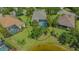An aerial view of the property featuring a screened-in pool, landscaping, and beautiful surroundings at 14350 Stirling Dr, Lakewood Ranch, FL 34202