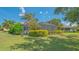 A sprawling backyard with a screened-in pool, lush landscaping, and plenty of space to enjoy at 14350 Stirling Dr, Lakewood Ranch, FL 34202