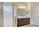 A modern bathroom features a walk-in shower, ample vanity space, and elegant finishes for a luxurious feel at 14350 Stirling Dr, Lakewood Ranch, FL 34202