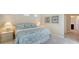 A peaceful bedroom showcases a comfortable bed with a coastal-themed comforter and serene decor for restful nights at 14350 Stirling Dr, Lakewood Ranch, FL 34202