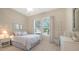 Cozy bedroom featuring neutral color palette, windows, and a comfortable bed at 14350 Stirling Dr, Lakewood Ranch, FL 34202