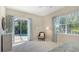 A bright bedroom features pool views, stylish coastal decor, and ample natural light for a serene living space at 14350 Stirling Dr, Lakewood Ranch, FL 34202