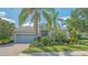 Charming one-story home with a neatly landscaped front yard, paver driveway, and an attached two-car garage at 14350 Stirling Dr, Lakewood Ranch, FL 34202