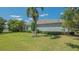 Well-maintained exterior of home with lush landscaping, mature trees, and beautiful backyard pond at 14350 Stirling Dr, Lakewood Ranch, FL 34202