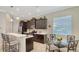 Charming kitchen featuring dark wood cabinets, stainless appliances, and bar seating at 14350 Stirling Dr, Lakewood Ranch, FL 34202