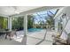 Enclosed lanai featuring a clear view of pool, surrounding nature, outdoor dining, and lounge seating at 14350 Stirling Dr, Lakewood Ranch, FL 34202