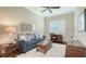 A comfortable living room features a plush sofa, stylish decor, and a bright window for a welcoming atmosphere at 14350 Stirling Dr, Lakewood Ranch, FL 34202