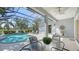 Enclosed lanai with clear view of pool, surrounding greenery, outdoor dining, and lounge seating at 14350 Stirling Dr, Lakewood Ranch, FL 34202
