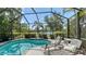 Relaxing screened-in pool area with comfortable lounge chairs and tranquil pond views at 14350 Stirling Dr, Lakewood Ranch, FL 34202