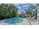 Inviting screened-in pool area with patio seating and view of lush landscaping at 14350 Stirling Dr, Lakewood Ranch, FL 34202