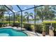 Screened-in pool with an inviting view of the pond and well-maintained landscaping at 14350 Stirling Dr, Lakewood Ranch, FL 34202