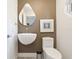 Chic powder room features a wall mounted sink, modern fixtures, and stylish mirror at 1493 Landings Lake Dr # 32, Sarasota, FL 34231