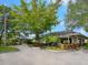 Clubhouse with well-manicured gardens and covered entryway at 1493 Landings Lake Dr # 32, Sarasota, FL 34231