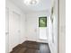 Clean, bright entryway featuring hardwood floors, a front door, white walls and a window at 1493 Gulf Of Mexico Dr #312, Longboat Key, FL at 1493 Landings Lake Dr # 32, Sarasota, FL 34231