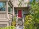Close up of exterior front door with red paint, a short stairway and greens at 1493 Gulf Of Mexico Dr #312, Longboat Key, FL at 1493 Landings Lake Dr # 32, Sarasota, FL 34231