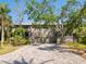 Charming exterior with a driveway, mature trees and multiple entryways at 1493 Gulf Of Mexico Dr #312, Longboat Key, FL at 1493 Landings Lake Dr # 32, Sarasota, FL 34231