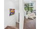 Hallway with art and stairway with glass panel, connecting the home's upper and lower levels at 1493 Landings Lake Dr # 32, Sarasota, FL 34231