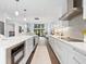 Sleek kitchen boasts white cabinetry, stainless steel appliances, and views to the home's exterior at 1493 Landings Lake Dr # 32, Sarasota, FL 34231