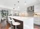 Modern kitchen features a large island with seating, stainless steel appliances, and ample counter space at 1493 Landings Lake Dr # 32, Sarasota, FL 34231