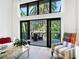 Bright living room with sliding glass doors to a deck, modern seating and hardwood floors at 1493 Gulf Of Mexico Dr #312, Longboat Key, FL at 1493 Landings Lake Dr # 32, Sarasota, FL 34231