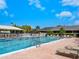 Large community swimming pool featuring lounge chairs, umbrellas, and mature landscaping for resort-style living at 1493 Landings Lake Dr # 32, Sarasota, FL 34231