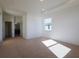 Bright bedroom featuring recessed lights, neutral carpet, and a large window for natural light at 15543 Trinity Fall Way, Bradenton, FL 34212