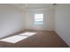 This bedroom has a bright neutral carpet, recessed lighting, and a large window at 15543 Trinity Fall Way, Bradenton, FL 34212