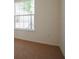 Comfortable bedroom with plush carpet, a large window offering natural light, and soothing, neutral walls at 15543 Trinity Fall Way, Bradenton, FL 34212