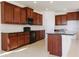Well-equipped kitchen with sleek black appliances, granite countertops, ample wood cabinetry, and a center island at 15543 Trinity Fall Way, Bradenton, FL 34212