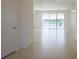 Bright, open living area with tile floors and large sliding glass doors offering lake views at 15543 Trinity Fall Way, Bradenton, FL 34212