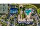 Aerial view of community amenities with a pool, tennis courts, basketball court, and lush landscaping at 1586 Dorgali Dr, Sarasota, FL 34238