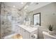Modern bathroom with a double vanity, a glass enclosed shower, and marble style tile at 1586 Dorgali Dr, Sarasota, FL 34238