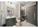 Bathroom featuring modern vanity with a wood framed mirror, a glass shower and neutral walls and floors at 1586 Dorgali Dr, Sarasota, FL 34238