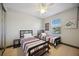 Bright bedroom with two beds, neutral walls, and ceiling fan for comfort at 1586 Dorgali Dr, Sarasota, FL 34238