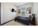 Bedroom featuring a single bed, neutral walls and carpet, and a window with natural sunlight at 1586 Dorgali Dr, Sarasota, FL 34238