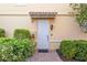 Inviting entryway with a white front door, red brick walkway, and lush landscaping at 1586 Dorgali Dr, Sarasota, FL 34238
