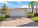 Charming home with a paver driveway and a two-car garage door and well maintained landscaping at 1586 Dorgali Dr, Sarasota, FL 34238