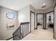 Bright hallway with an octagon window, neutral walls, and carpeted floors leading to various rooms in the home at 1586 Dorgali Dr, Sarasota, FL 34238