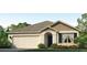 Charming single-story home with a neutral color scheme, attached garage, and landscaped front yard at 17214 Whiskey Creek Trl, Parrish, FL 34219