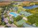 Overhead image showing the community's pool, tennis courts, and recreational areas surrounded by trees at 18106 Canal Pointe St, Tampa, FL 33647